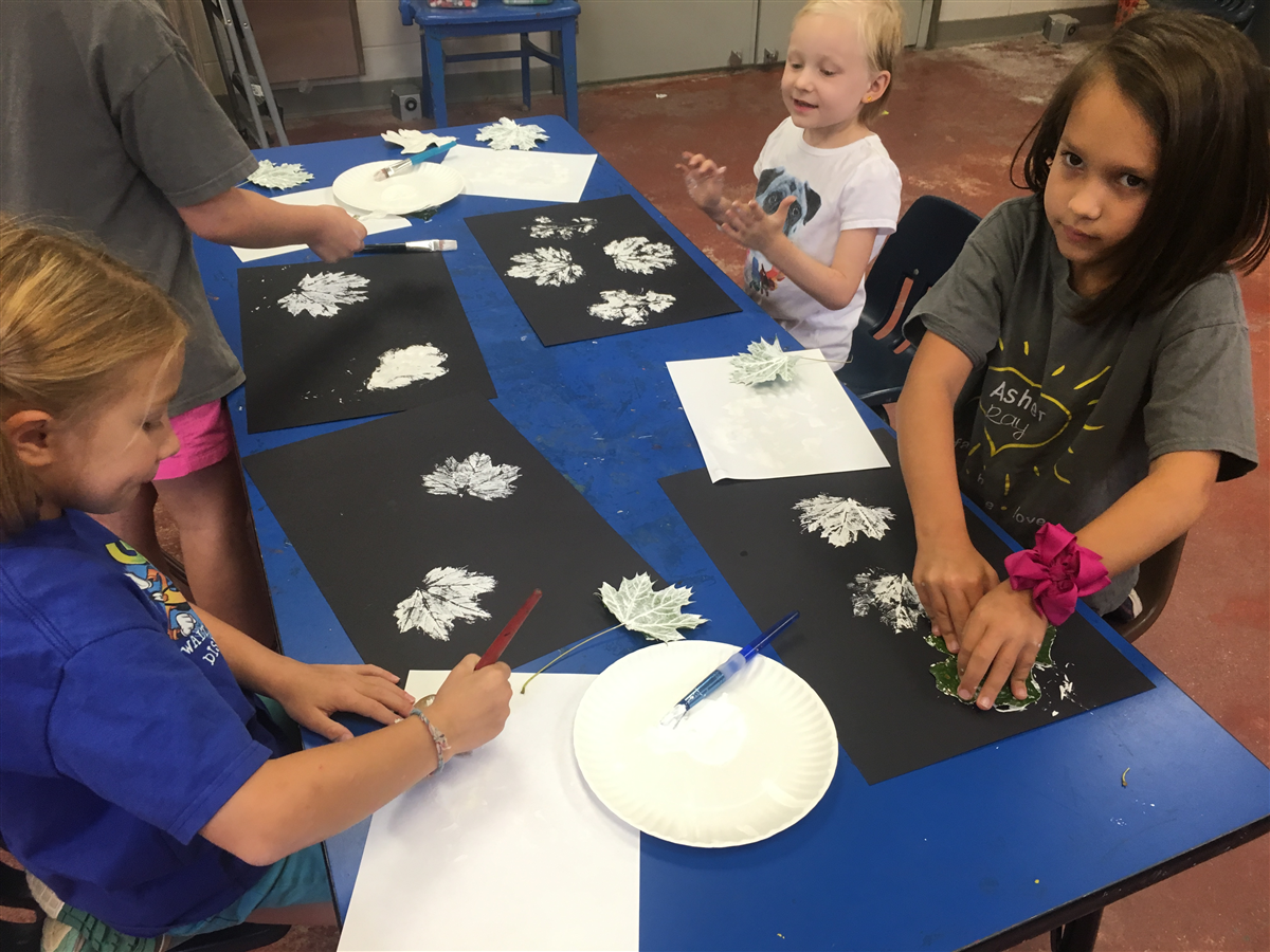 2nd graders making beautiful prints with leaves!